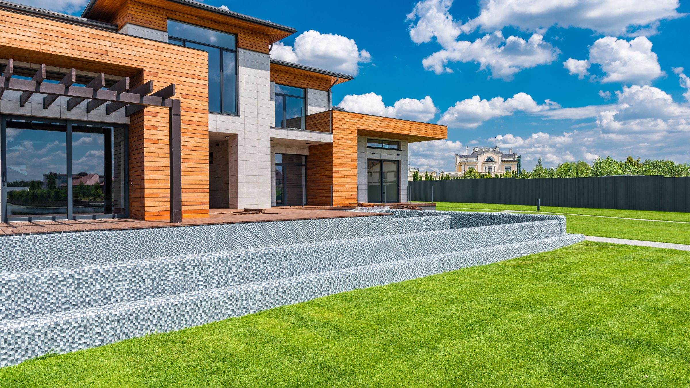 A modern Auckland home with a designed lawn and layered planting